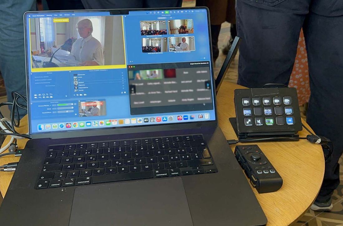 Multi-camera Zoom live streaming control setup on a laptop at a ceremony